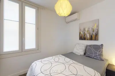 a bedroom with a bed and two windows at Grand Suite Promenade Five stars holiday house in Nice