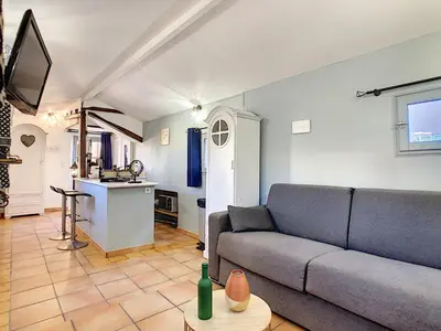 a living room with a couch and a kitchen at Le Mirador du Vieux Nice in Nice