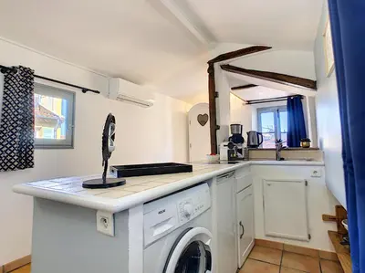 a kitchen with a washing machine and a sink at Le Mirador du Vieux Nice in Nice