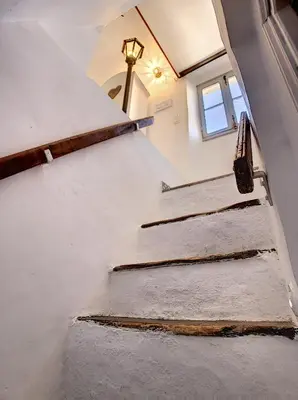 a set of stairs in a room with a window at Le Mirador du Vieux Nice in Nice