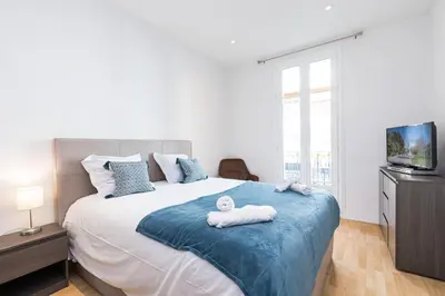 a bedroom with a large bed with towels on it at FEEL HOME - Congrès 13 in Nice