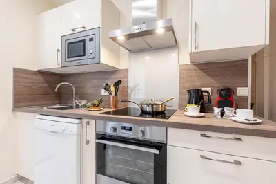 a kitchen with a stove and a microwave at FEEL HOME - Congrès 13 in Nice