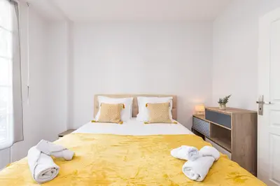 a bedroom with a large bed with towels on it at FEEL HOME - Congrès 13 in Nice