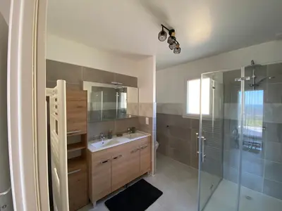 a bathroom with a sink and a glass shower at Villa Flora in La Gaude