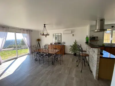 a kitchen and dining room with a table and chairs at Villa Flora in La Gaude