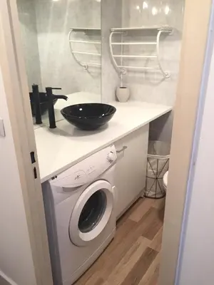 a laundry room with a washing machine and a sink at Studio à 2 pas de la promenade des anglais in Nice