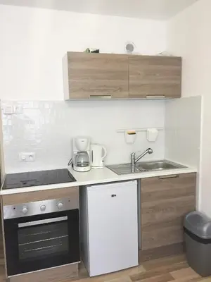 a small kitchen with a sink and a stove at Studio à 2 pas de la promenade des anglais in Nice