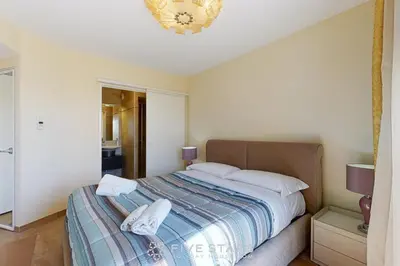 a bedroom with a bed and a chandelier at LUXURY BEACH five STARS HOLIDAY HOUSE in Nice