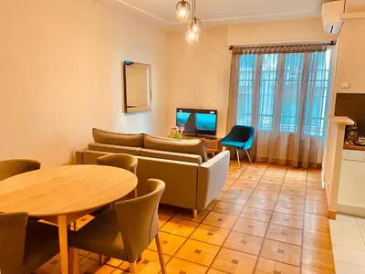 a living room with a couch and a table at City center cute flat with sea view one bedroom in Nice