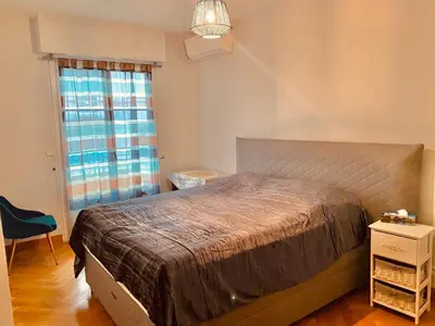 a bedroom with a large bed and a window at City center cute flat with sea view one bedroom in Nice