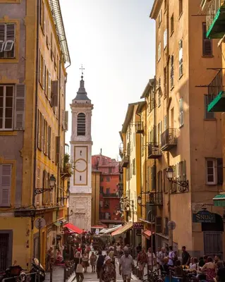 a clock tower in a city with a crowd of people at Appartement 3 pièces Nice Hypercentre in Nice