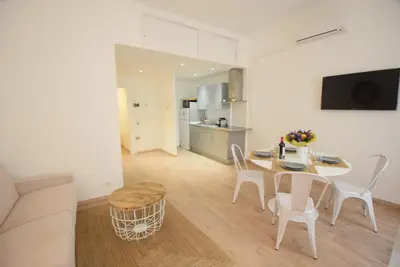 a kitchen and dining room with a table and chairs at Nice Renting - BARILLERIE - COZY LOFT OLD NICE - SEA FRONT - SALEYA - MASSENA in Nice