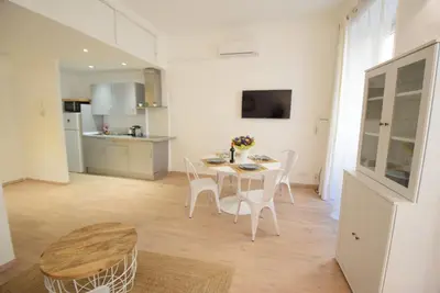 a kitchen and dining room with a table and chairs at Nice Renting - BARILLERIE - COZY LOFT OLD NICE - SEA FRONT - SALEYA - MASSENA in Nice