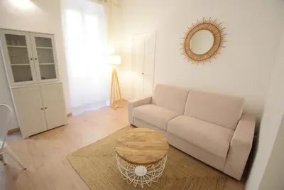 a living room with a couch and a table at Nice Renting - BARILLERIE - COZY LOFT OLD NICE - SEA FRONT - SALEYA - MASSENA in Nice