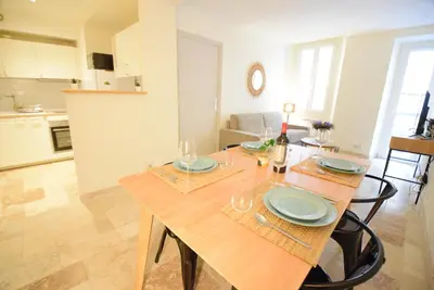 a dining room and kitchen with a wooden table at Nice Renting - PAIROLIERE - SPACIOUS FLAT - OLD NICE - MASSENA - TERRACE in Nice