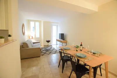 a dining room with a table and a couch at Nice Renting - PAIROLIERE - SPACIOUS FLAT - OLD NICE - MASSENA - TERRACE in Nice