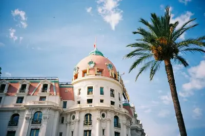 a building with a palm tree in front of it at Nice Renting - PAIROLIERE - SPACIOUS FLAT - OLD NICE - MASSENA - TERRACE in Nice