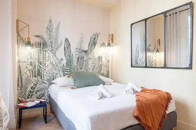 a bedroom with a bed with a mirror on the wall at 60 HEROLD - Magnifique Studio - Terrasse - Climatise in Nice