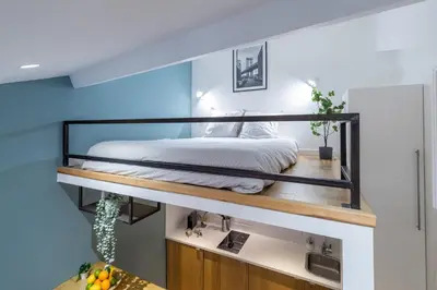 a bedroom with a bed on a shelf above a sink at 1 GALLO LOT 2 - Studio Mezzanine en plein coeur du vieux Nice in Nice