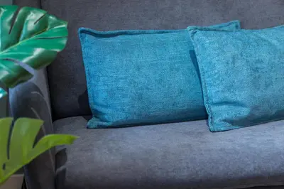 a blue pillow sitting on a couch with a plant at 1 GALLO LOT 2 - Studio Mezzanine en plein coeur du vieux Nice in Nice