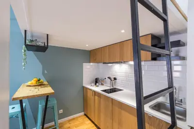 a kitchen with a staircase leading up to a loft at 1 GALLO LOT 2 - Studio Mezzanine en plein coeur du vieux Nice in Nice