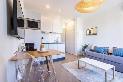 a living room with a couch and a table at 2 BAVASTRO - Beau 2 pieces lumineux et cosy - Climatise in Nice