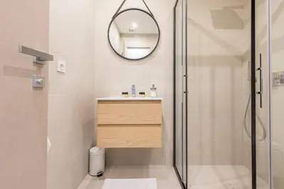 a bathroom with a shower and a sink and a mirror at 2 BAVASTRO - Beau 2 pieces lumineux et cosy - Climatise in Nice