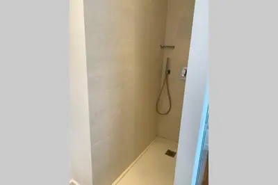 a bathroom with a shower with a glass door at Le Lafayette HP in Nice