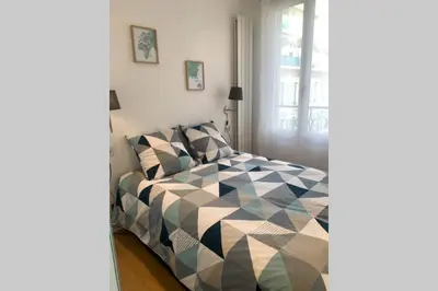 a bedroom with a bed and a window at Le Lafayette HP in Nice