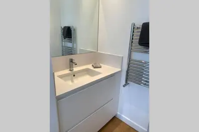 a room with a large glass door leading to a bathroom at Le Lafayette HP in Nice