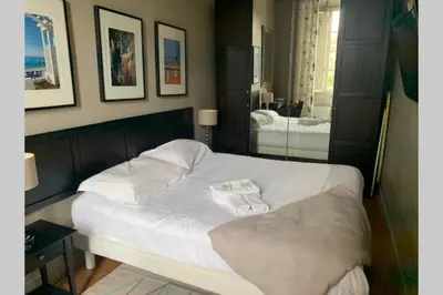 a bedroom with a white bed and a mirror at 18 Garibaldi in Nice