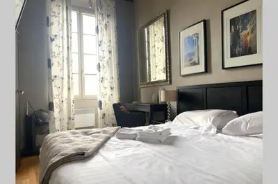 a bedroom with a large white bed and a window at 18 Garibaldi in Nice