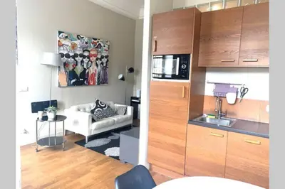 a kitchen and a living room with a couch at 18 Garibaldi in Nice