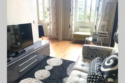 a living room with a couch and a flat screen tv at 18 Garibaldi in Nice