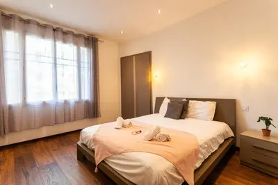 a bedroom with a large bed with towels on it at BAMBOO PLAGE AP4220 by Riviera Holiday Homes in Nice