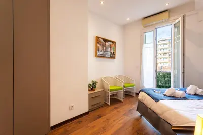 a bedroom with a bed and a window at BAMBOO PLAGE AP4220 by Riviera Holiday Homes in Nice