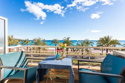 a table on a balcony with a view of the ocean at BAMBOO PLAGE AP4220 by Riviera Holiday Homes in Nice