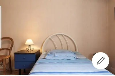 a bedroom with a bed and a table with a lamp at Chambre chez particulier centre ville - Nice in Nice