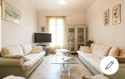 a living room with a couch and a tv at Chambre chez particulier centre ville - Nice in Nice