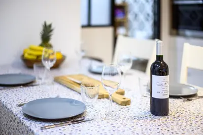 a bottle of wine sitting on a table with glasses at Magnifique appartement au centre-ville de Nice in Nice