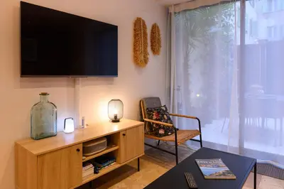 a living room with a flat screen tv on the wall at Magnifique appartement au centre-ville de Nice in Nice