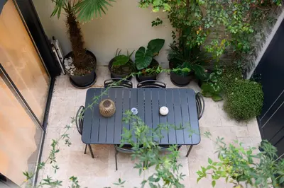a blue table and a bunch of potted plants at Magnifique appartement au centre-ville de Nice in Nice