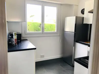 a kitchen with a refrigerator and a window at Beautiful T3 terrasse Nice in Nice