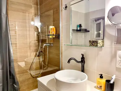 a bathroom with a shower with a toilet and a sink at Cosy modern studio in the heart of Nice with AC in Nice