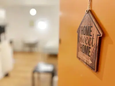 a sign that reads house sweet home hanging on a wall at Cosy modern studio in the heart of Nice with AC in Nice