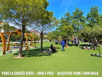 a park with people sitting on the grass at Cosy modern studio in the heart of Nice with AC in Nice