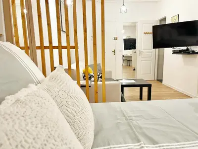 a bedroom with a bed and a living room at Cosy modern studio in the heart of Nice with AC in Nice