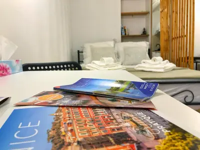 a table with magazines on top of it at Cosy modern studio in the heart of Nice with AC in Nice