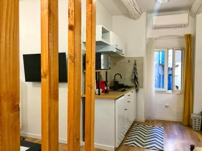 a kitchen with white walls and a counter top at Cosy modern studio in the heart of Nice with AC in Nice