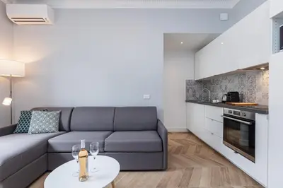 a living room with a couch and a table at ChezDudi in Nice